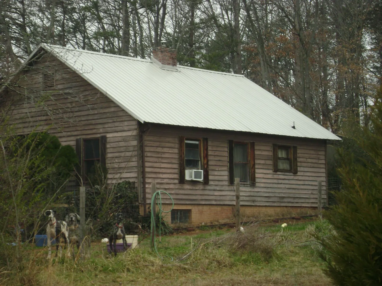 White metal roof on an old wood sided farmhouse, from a Metal Roof Installation job in Owego